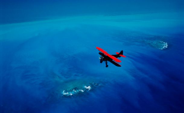 Red Waco Biplane over Key West, Florida keys National Marine Sanctuary